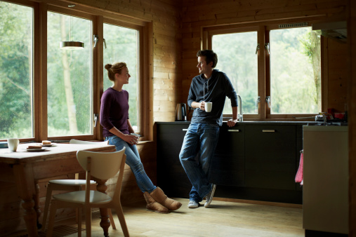 Full length of couple having coffee in cottage