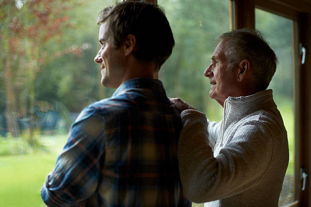 thoughtful father and son in cottage - greenback fotografías e imágenes de stock