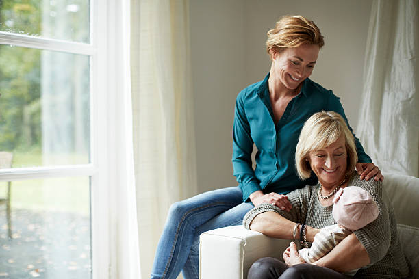 happy family of three generations on sofa - two generation family стоковые фото и изображения