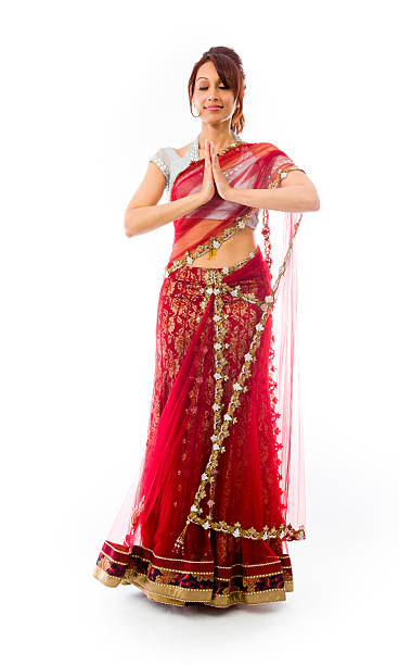 istock Young Indian woman standing in prayer position 499551277
