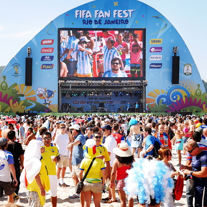 Rio de Janeiro, Brazil - June 25, 2014: A large crowd of soccer fans from various nations enjoying the atmosphere of the FIFA Fan Fest on Ipanema beach, Rio.  There are numerous Fan Fest locations throughout Brazil created to provide a spot for fans to watch games during the soccer World Cup tournament.