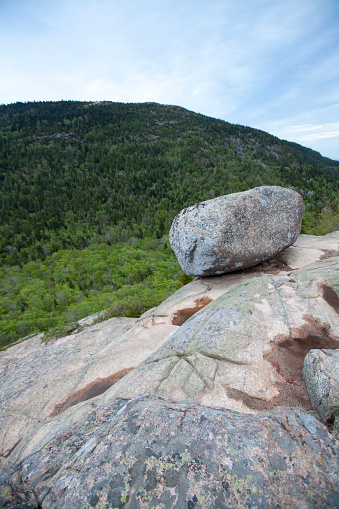 Bubble Rock (aka. Balanced Rock), a large boulder that was carried by glaciers and deposited at the seemingly precarious edge of a cliff in Acadia National Park, Maine.