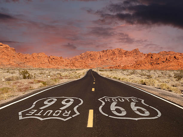 istock Route 66 Pavement Sign with Red Rock Mountain Sunset 499553489