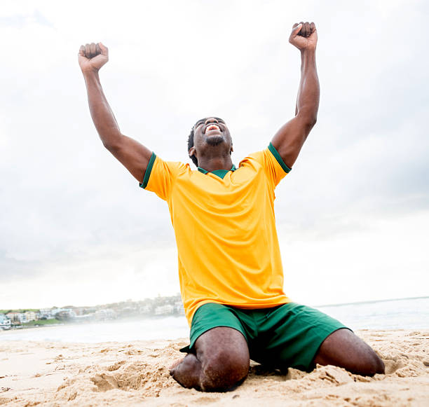 hombre celebrando un gol - beach football fotografías e imágenes de stock