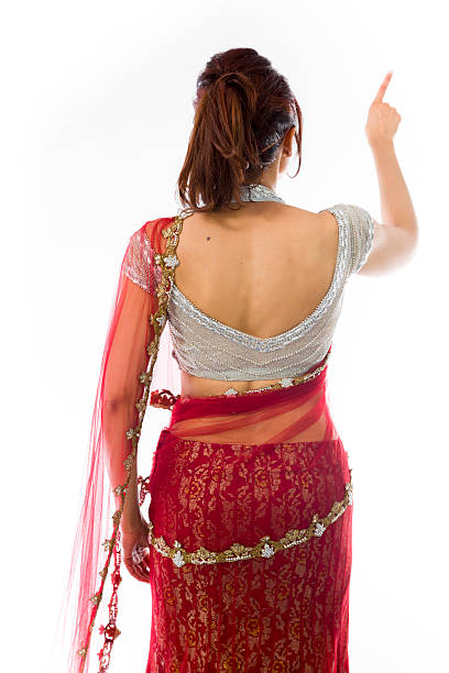 istock Young Indian woman pretending to work on touch screen 499554731