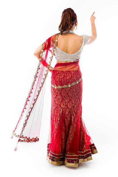 istock Young Indian woman pretending to work on touch screen 499554755