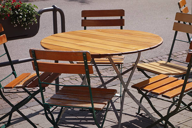 istock Round wooden restaurant table and chairs outdoor 499556797