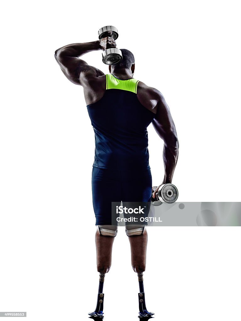 handicapped body builders building weights man with legs prosthesis one muscular handicapped man body builders building weights with legs prosthesis in silhouette on white background Disability Stock Photo