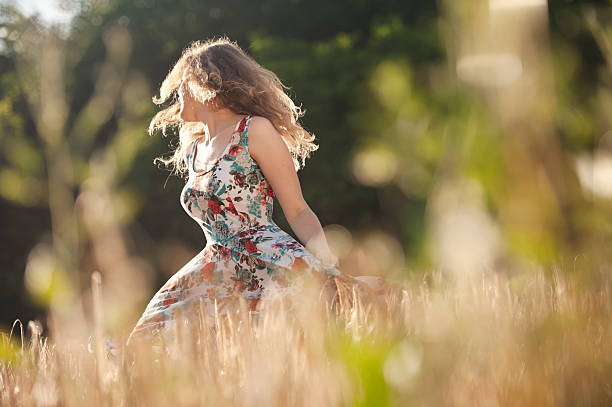 istock Young Beautiful Woman Dancing in the Wheat Field 499564567