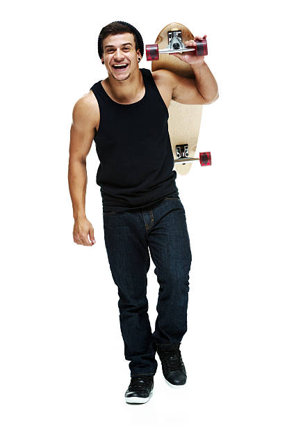 istock Cheerful man walking & holding skateboard 499565651