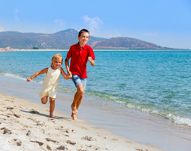 istock Sister and brother on a beach 499565797