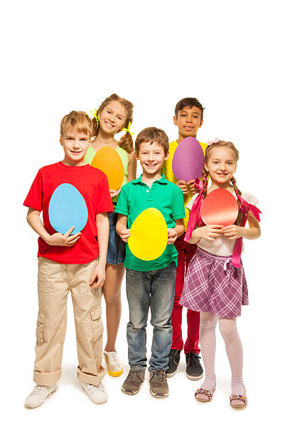 istock Smiling kids holding egg shape colourful cards 499566633