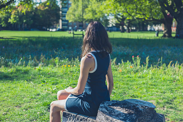 istock Young woman relaxing on log in park 499566668