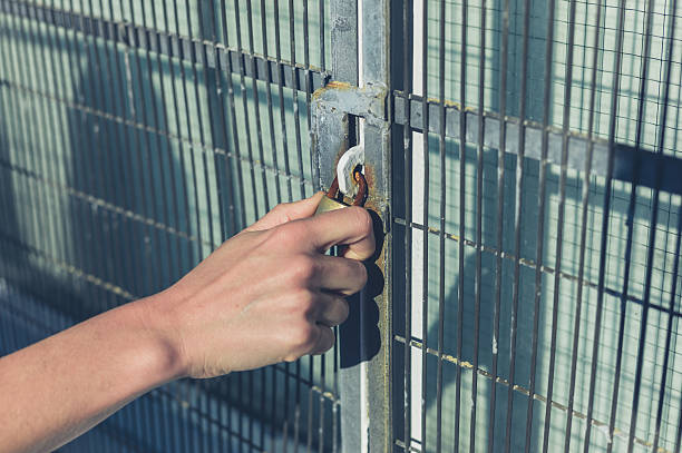 istock Female hand grabbing a padlock 499566948
