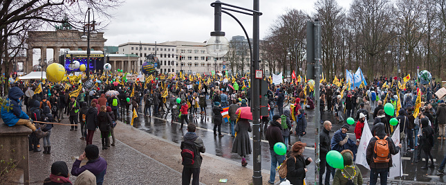 Berlin, Germany - November 29, 2015: Final rally of the Global Climate March in Berlin (Germany) on 30th November 2015, one day before beginning of the world climate conference in Paris. In the background is seen the Brandenburg Gate.