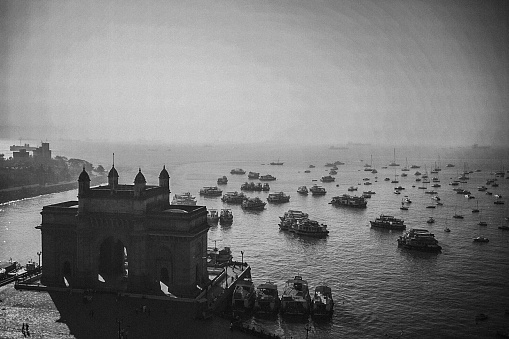 The Gateway of India is a monument built during the British Raj in Mumbai City of Maharashtra state in Western India. Gateway of India is located on the waterfront in the Apollo Bunder area in South Mumbai and overlooks the Arabian Sea. The structure is a basalt arch, 26 metres (85 feet) high. It lies at the end of Chhatrapati Shivaji Marg at the water's edge in Mumbai Harbour. It was a crude jetty used by the fishing community which was later renovated and used as a landing place for British governors and other prominent people. In earlier times, it would have been the first structure that visitors arriving by boat in Mumbai would have seen. The Gateway has also been referred to as the Taj Mahal of Mumbai, and is the city's top tourist attraction.