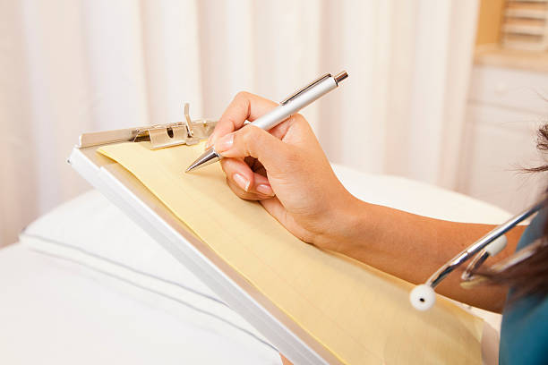 istock Doctor or nurse taking notes in clinic, doctor's office. 499569811