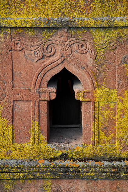 Lalibela, Ethiopia: rock-hewn Church of Saint George Lalibela, Amhara region, Ethiopia: ornate window at the rock-hewn Church of Saint George / Biete Giyorgis - carved from red volcanic rock in the shape of a cross - 12th century - the most famous of the eleven monolithic churches in Lalibela - Ethiopian Orthodox Tewahedo Church - UNESCO world heritage site - photo by M.Torres the church of saint george lalibela ethiopia stock pictures, royalty-free photos & images