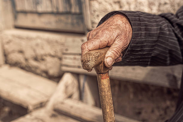 istock hand of a old man holding a cane 499570516