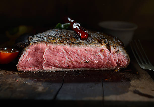 istock steak on the wooden background with roasted vegetables 499570520