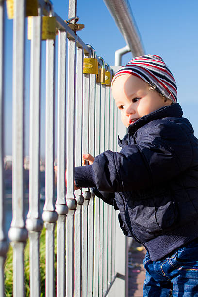 istock little child looks through the grid 499570796