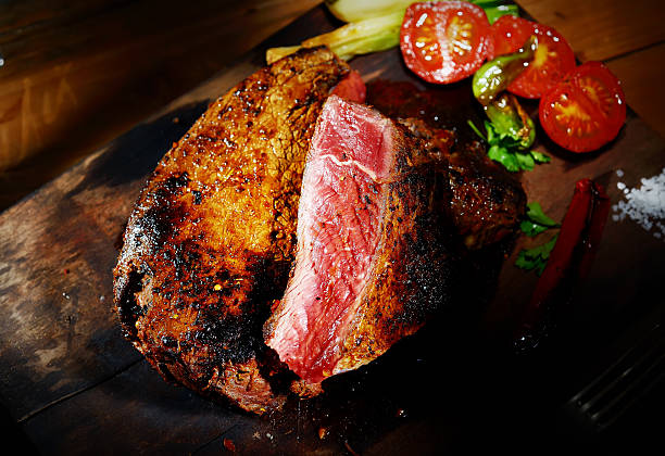 istock steak on the wooden background with roasted vegetables 499570842