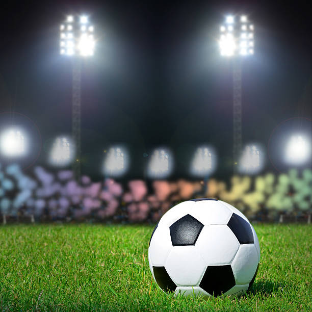 istock Football on the field with stadium light 499570869