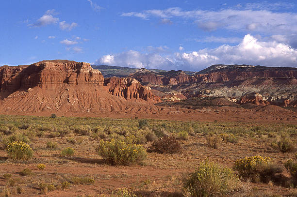 Sagebrush valley rocky cliffs clouds in background near Boulder Utah