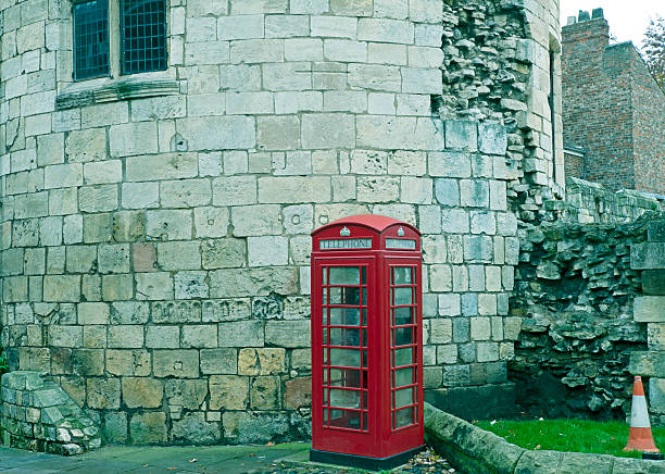 istock Telephone booth by ancient Roman tower in York UK 499572396