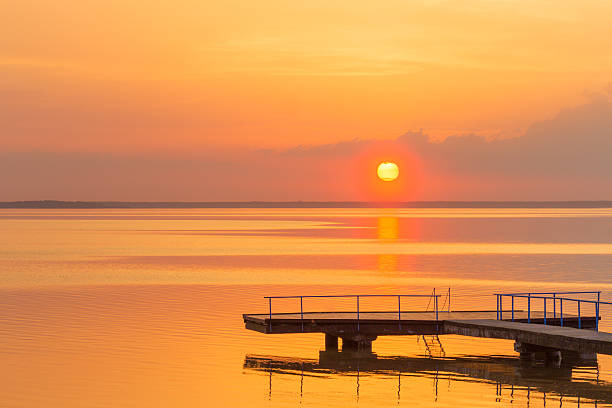 istock Sunset over water lake coast water summer landscape 499572914