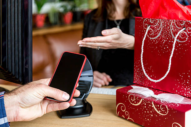 istock Man Paying With NFC Technology on Smart Phone in Store 499573098