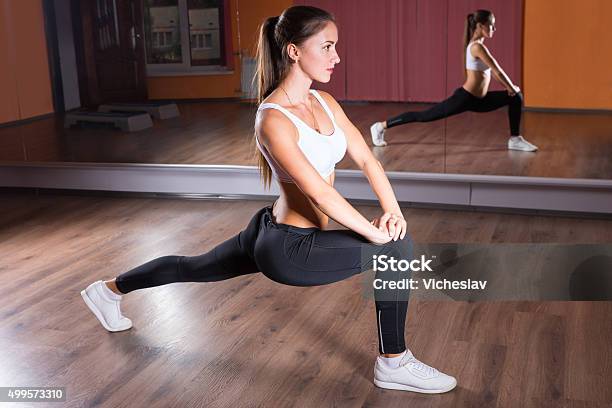 Young Woman Stretching In Lunge Position Stock Photo - Download Image Now - 2015, Active Lifestyle, Activity