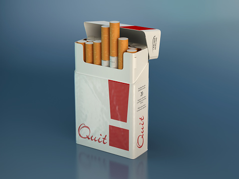A cigarette box named quit on blue background