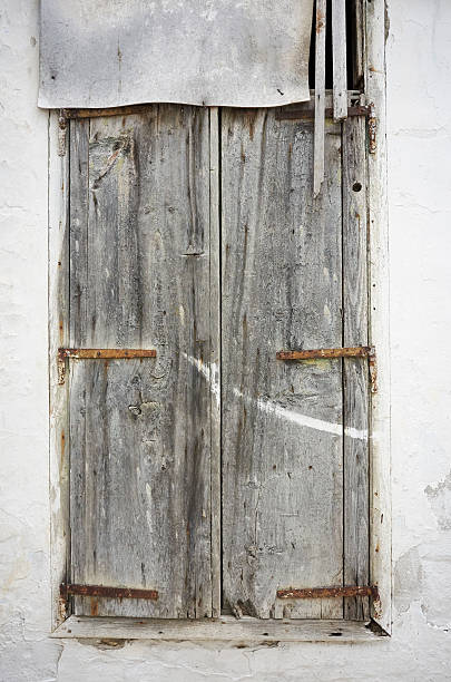 istock White weathered gates made of boards in a wall 499574332