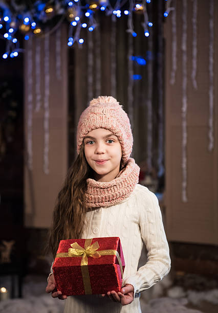 istock girl with christmas gift box 499575272