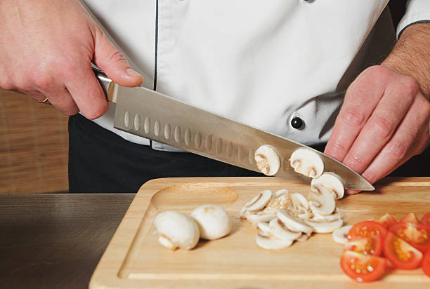 istock chef cutting mushrooms and tomats 499577330