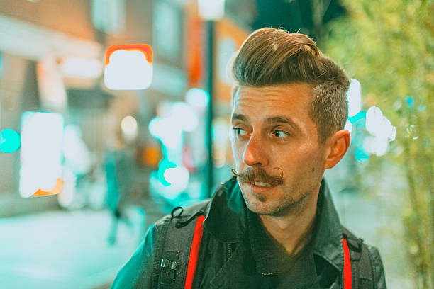 istock Young man in the street at night 499577770