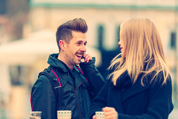 istock Young couple drinking in street cafe 499577990