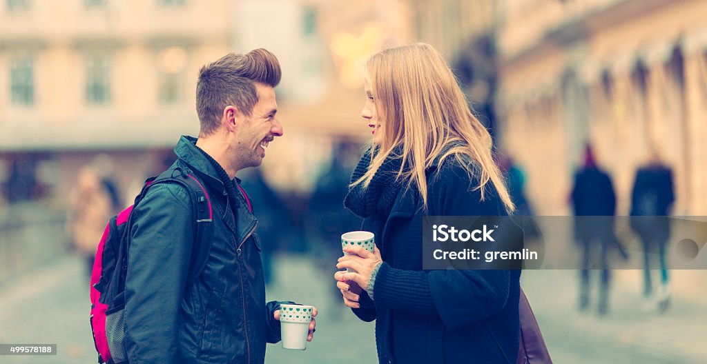 Urban young couple talking on the streets Urban young couple talking on the streets. 2015 Stock Photo