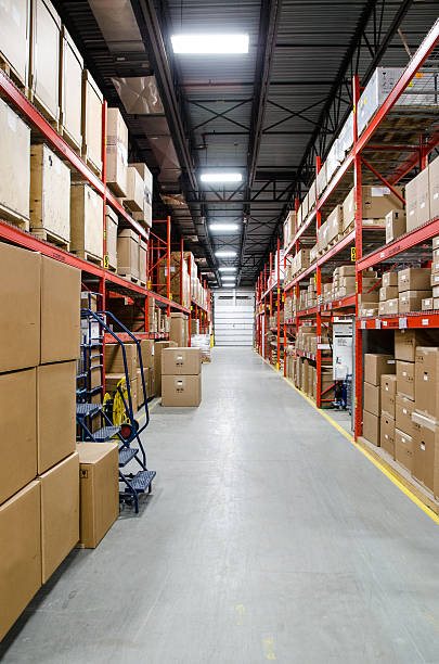 istock Warehouse alley with shelves full of boxes on each side 499578708