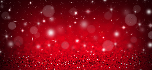 Christmas background with red glitters, sparkles and bokeh