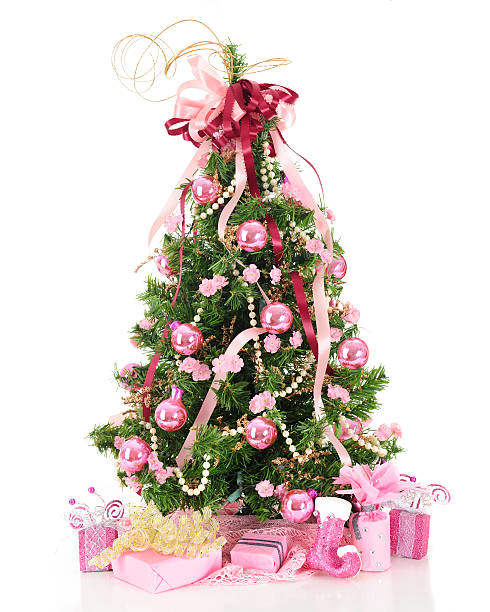 Feminine Kind of Christmas A beautiful, full Christmas tree decorated in pearls and pink  flowers, ribbons and shiny bulbs.  A lacy pink skirt and pretty pink-decorated gifts  surround the base.  On a white background. pink christmas tree stock pictures, royalty-free photos & images