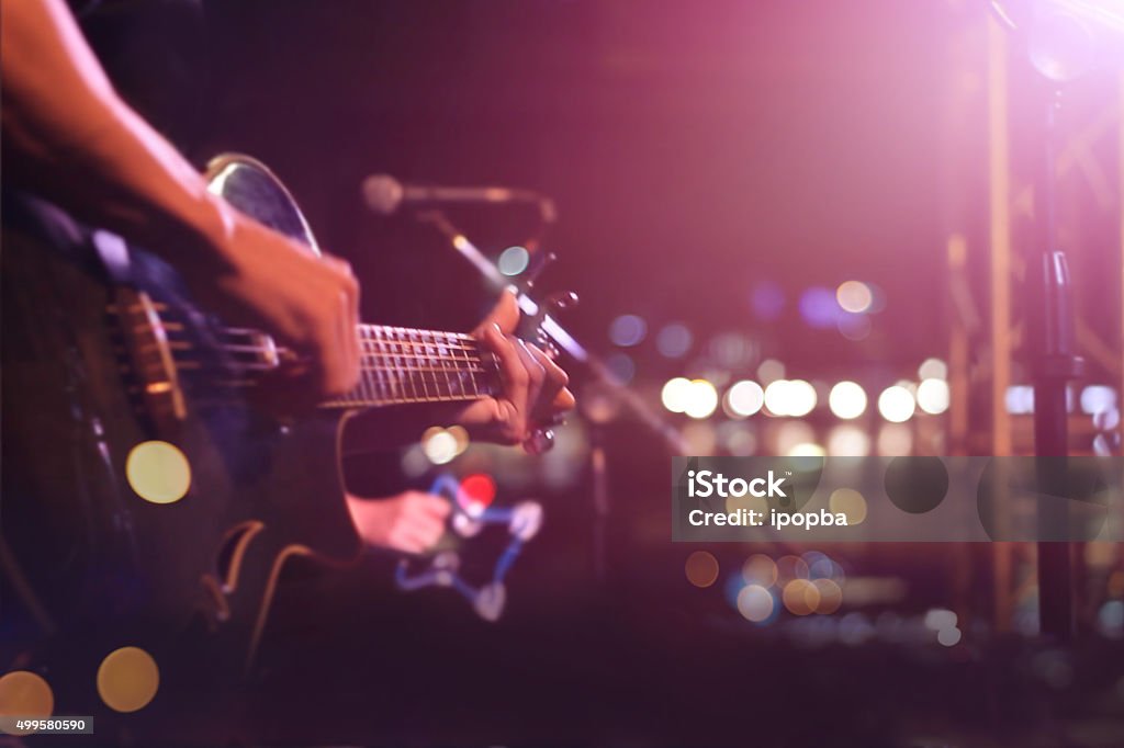 Guitarist on stage for background, soft and blur concept Performance Group Stock Photo