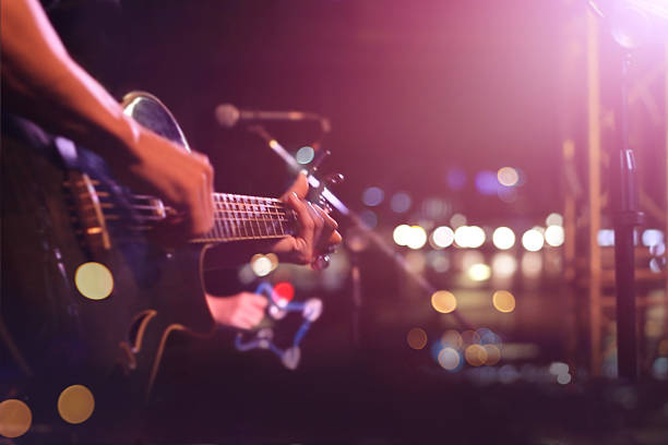 Guitarist on stage for background, soft and blur concept Guitarist on stage for background, soft and blur concept bass instrument photos stock pictures, royalty-free photos & images