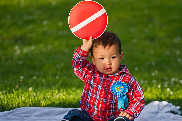 istock Toddler child sitting down in a park 499584569