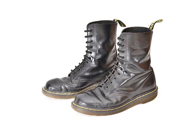 Pair of classic Dr. Martens (docs) black lace-up boots Tel Aviv, Israel - June 25, 2014:  A pair of 10 eyelet classic Dr. Martens (docs) black lace-up combat boots (illustrative editorial) lace up stock pictures, royalty-free photos & images