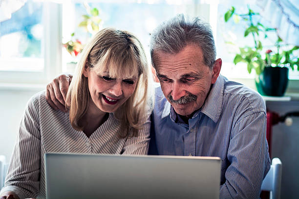 istock Senior couple looking at laptop 499594212