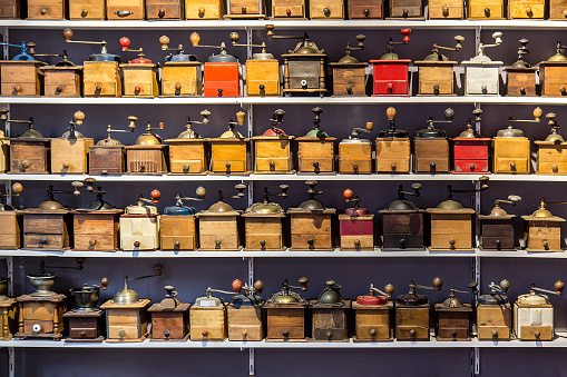 coffee grinders aligned in rows on store shelves, flea market Saint ouen, Paris, France