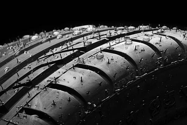 Wet car tire macro on black