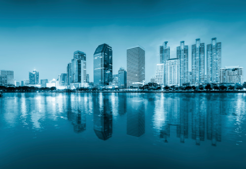 Scenery of bangkok (blue color tone) reflect on river.